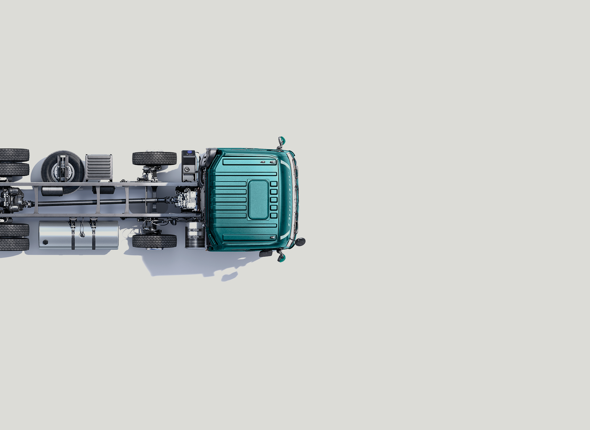 Teal truck chassis photographed from above on a light gray background.