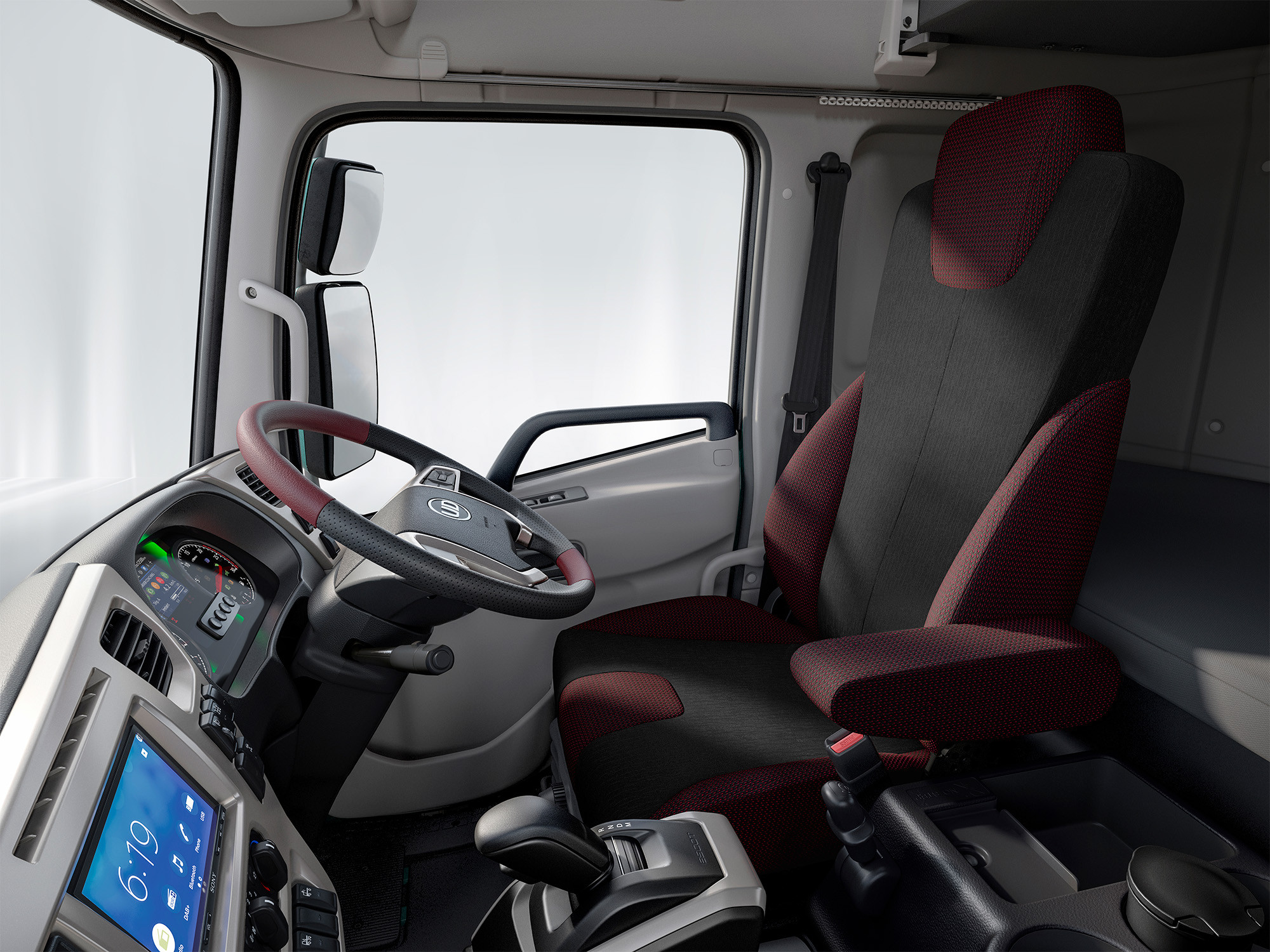 Modern truck cabin with a red and black driver's seat and digital dashboard.